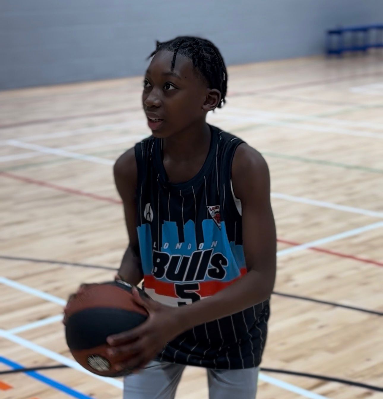 Next Gen Bulls player holding a basketball on court